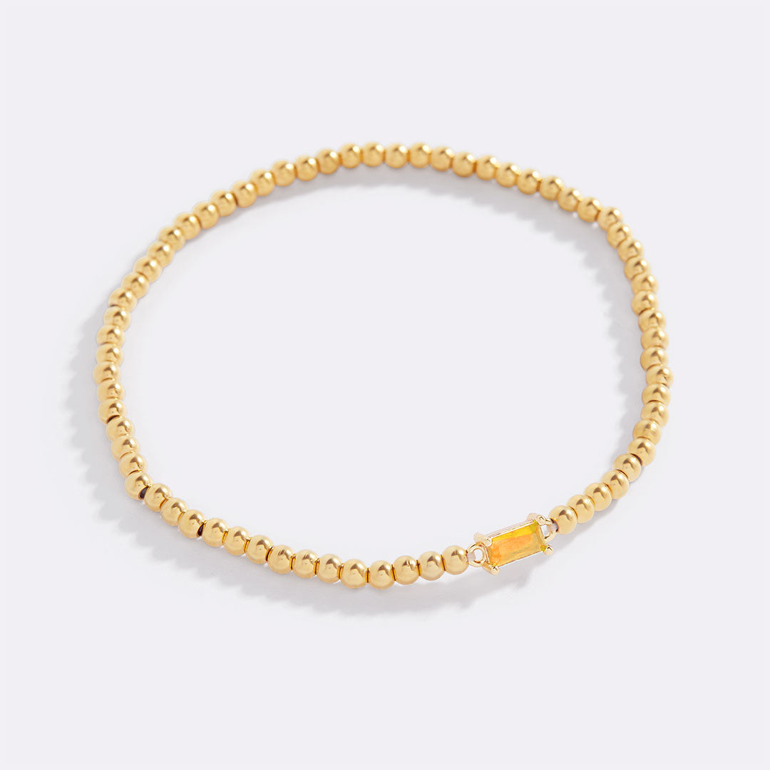 Bracelet of gold beads with birth stone