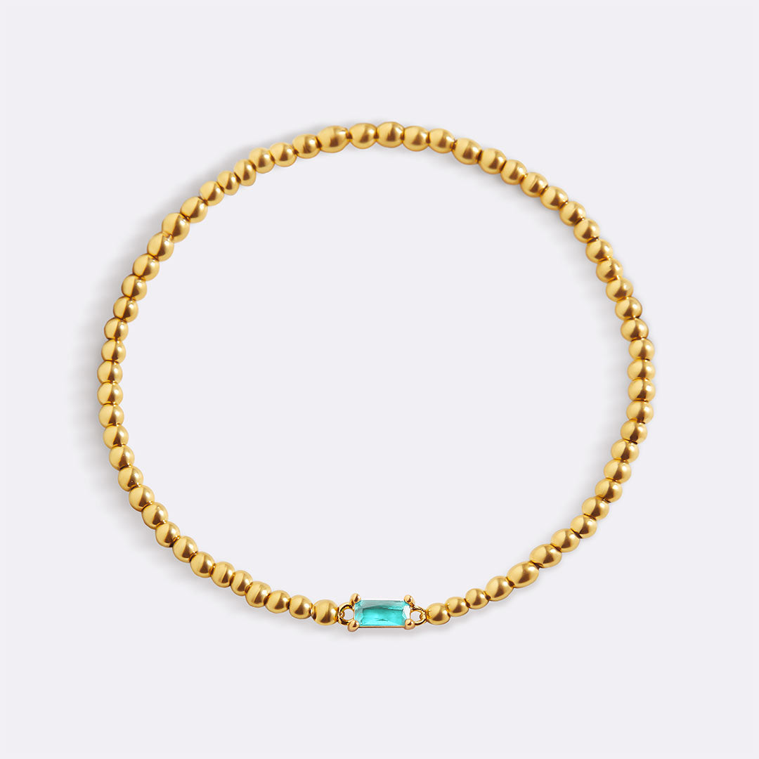 Bracelet of gold beads with birth stone